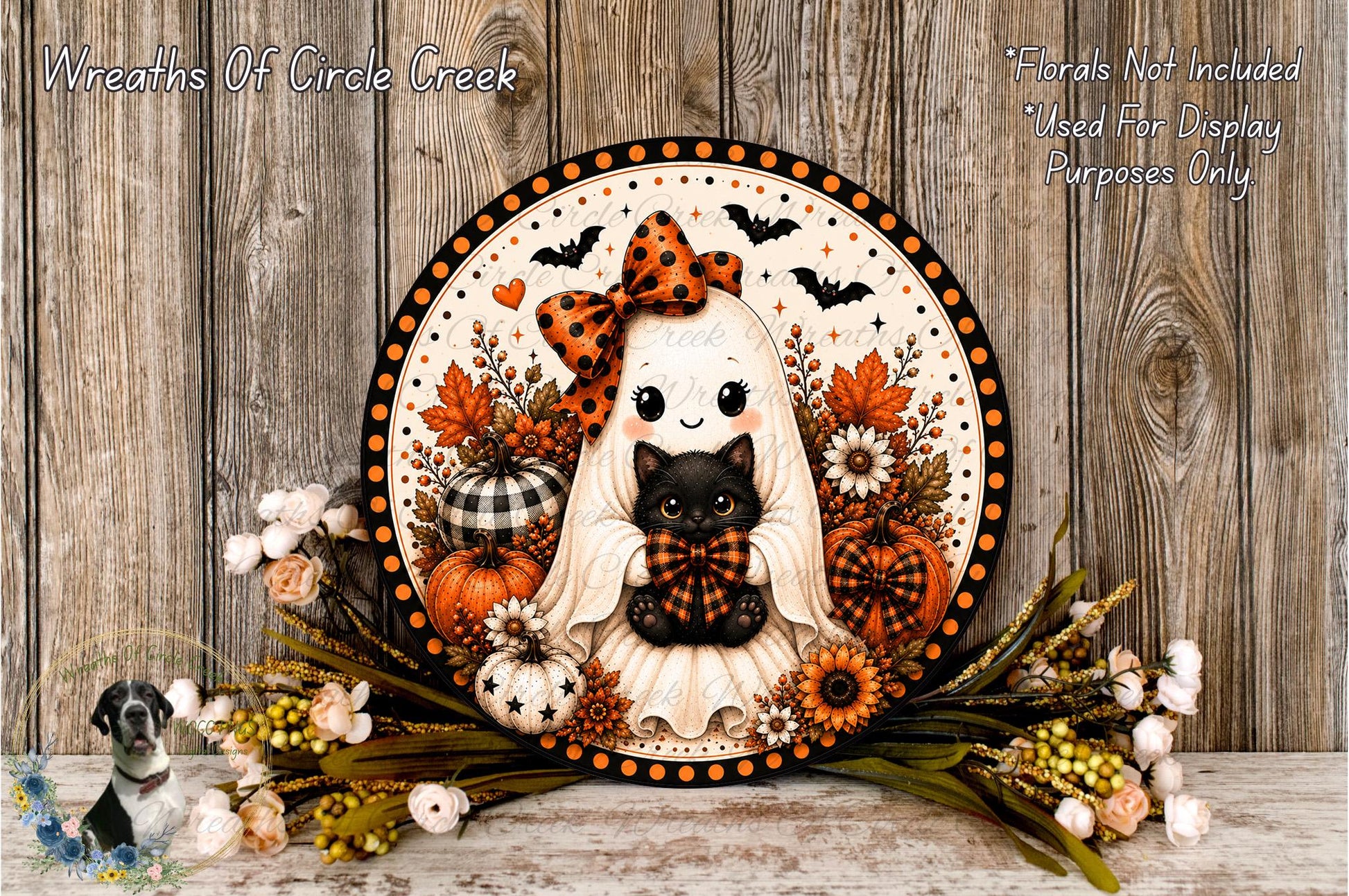 A decorative Halloween wreath featuring a ghost, a cat, and various fall-themed elements such as pumpkins, flowers, and a bow.