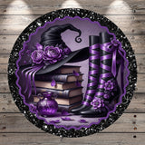 A witch's hat adorned with purple flowers, a stack of books, and purple boots with flower embellishments, all set against a purple and black background with a glittery border.