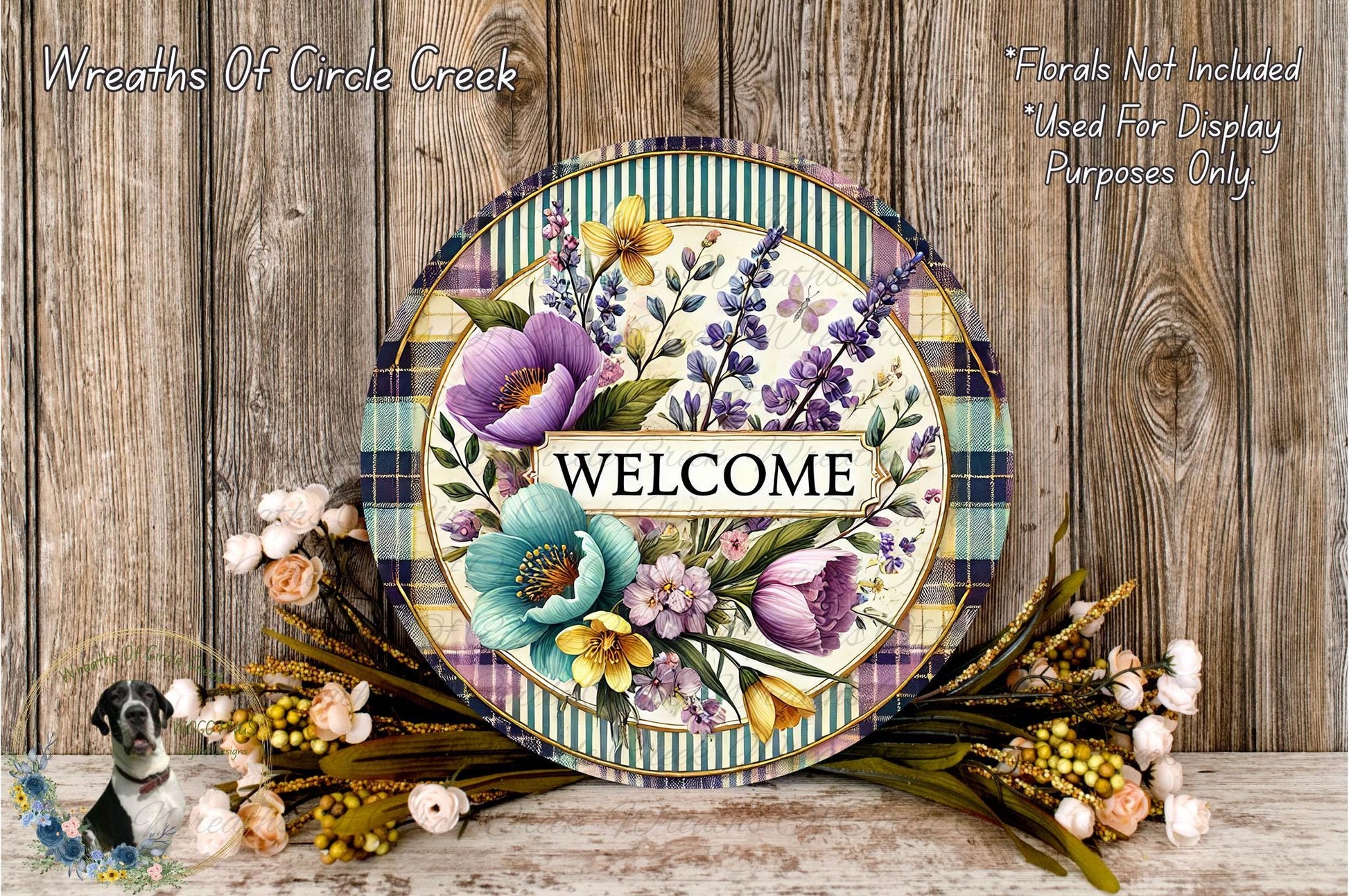 a decorative welcome sign with a floral design, surrounded by a wreath of flowers and greenery. The sign has the word "WELCOME" written on it, and the background is a wooden wall.