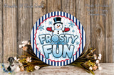 A circular sign with the text "FROSTY FUN" and a snowman figure, surrounded by a wreath of flowers and a wooden background.