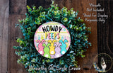 a wreath made of green leaves and colorful Easter bunny illustrations. The wreath is adorned with the text "Howdy Peeps" and includes a small sign with the text "Wreaths of Circle Creek".