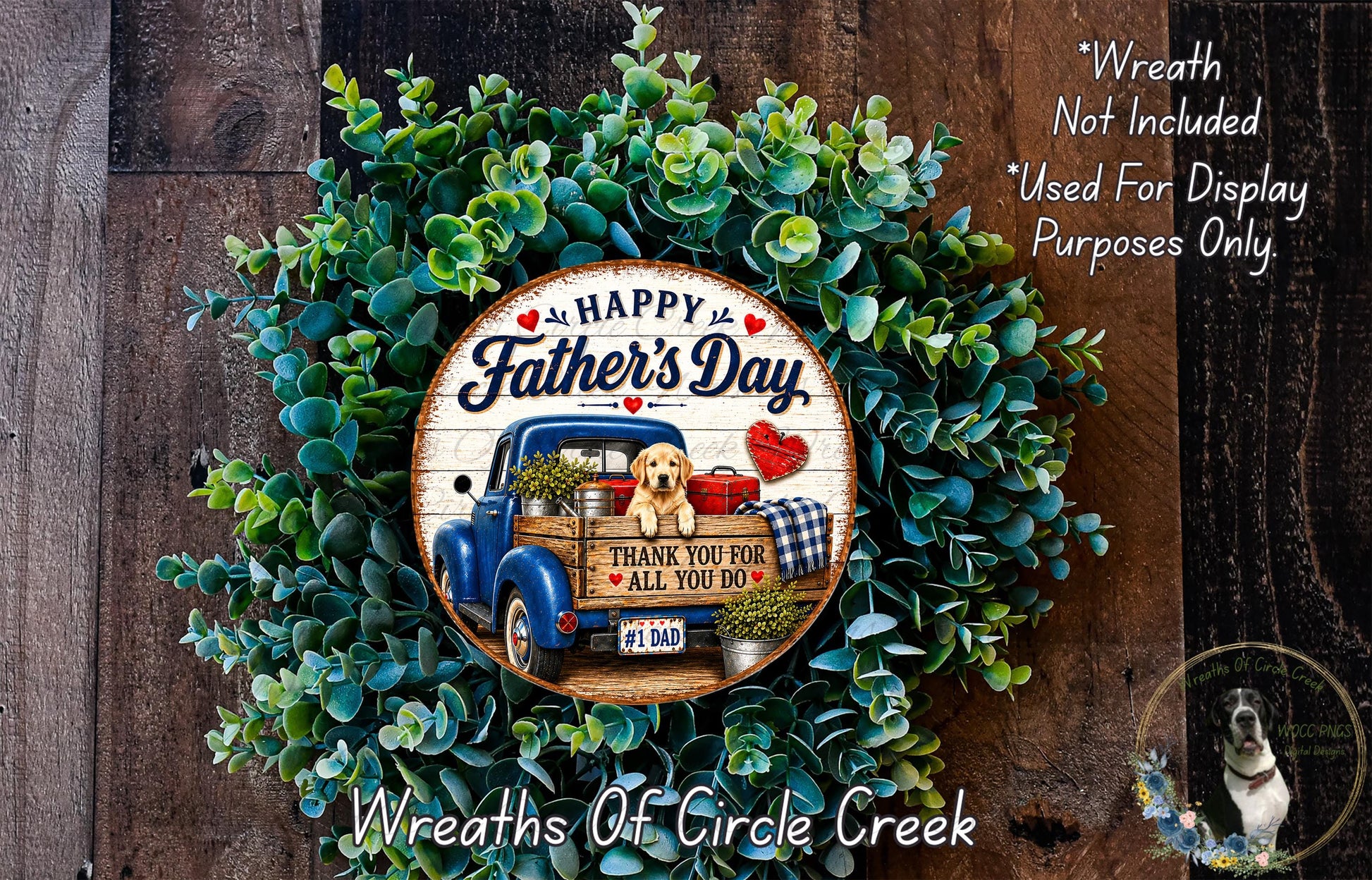 A wreath made of green leaves and a wooden sign with a picture of a blue truck and a dog, celebrating Father's Day.