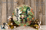 a round sign with a gnome wearing a green hat and holding a clover, surrounded by a floral arrangement and a basket.