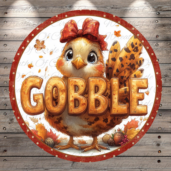 A cheerful illustration of a turkey wearing a red bow, surrounded by autumn leaves and the word "GOBBLE" prominently displayed in the center.