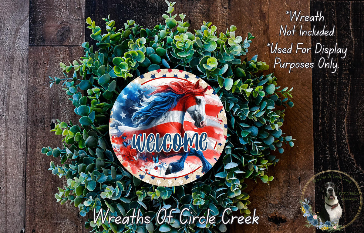 a wreath with a patriotic design, including an American flag and a horse, surrounded by greenery. The wreath is placed on a wooden surface, and there is a text overlay that reads "Welcome Wreath Not Included * Used For Display Purposes Only" and "Wreaths Of Circle Creek".