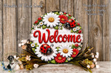 a decorative welcome sign with a floral design, surrounded by flowers and greenery.