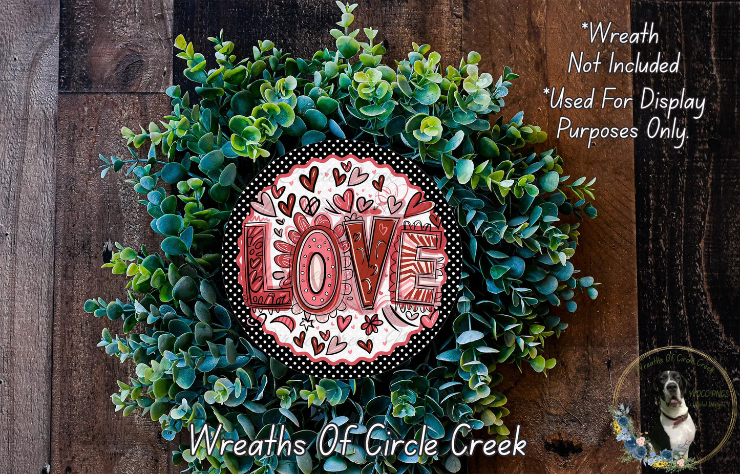 A wreath made of green leaves and flowers, with the word "LOVE" prominently displayed in the center.