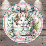 A white bunny peeking out of an Easter egg, surrounded by colorful flowers and a bow, with the word "Easter" written on the egg.