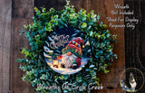 A wreath made of green leaves and a gnome figure, with the text "Merry Christmas" displayed on it.