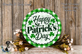 A circular sign with the text "Happy St. Patrick's Day" surrounded by a green and white checkered border, placed on a wooden surface with a floral arrangement and a dog in the background.
