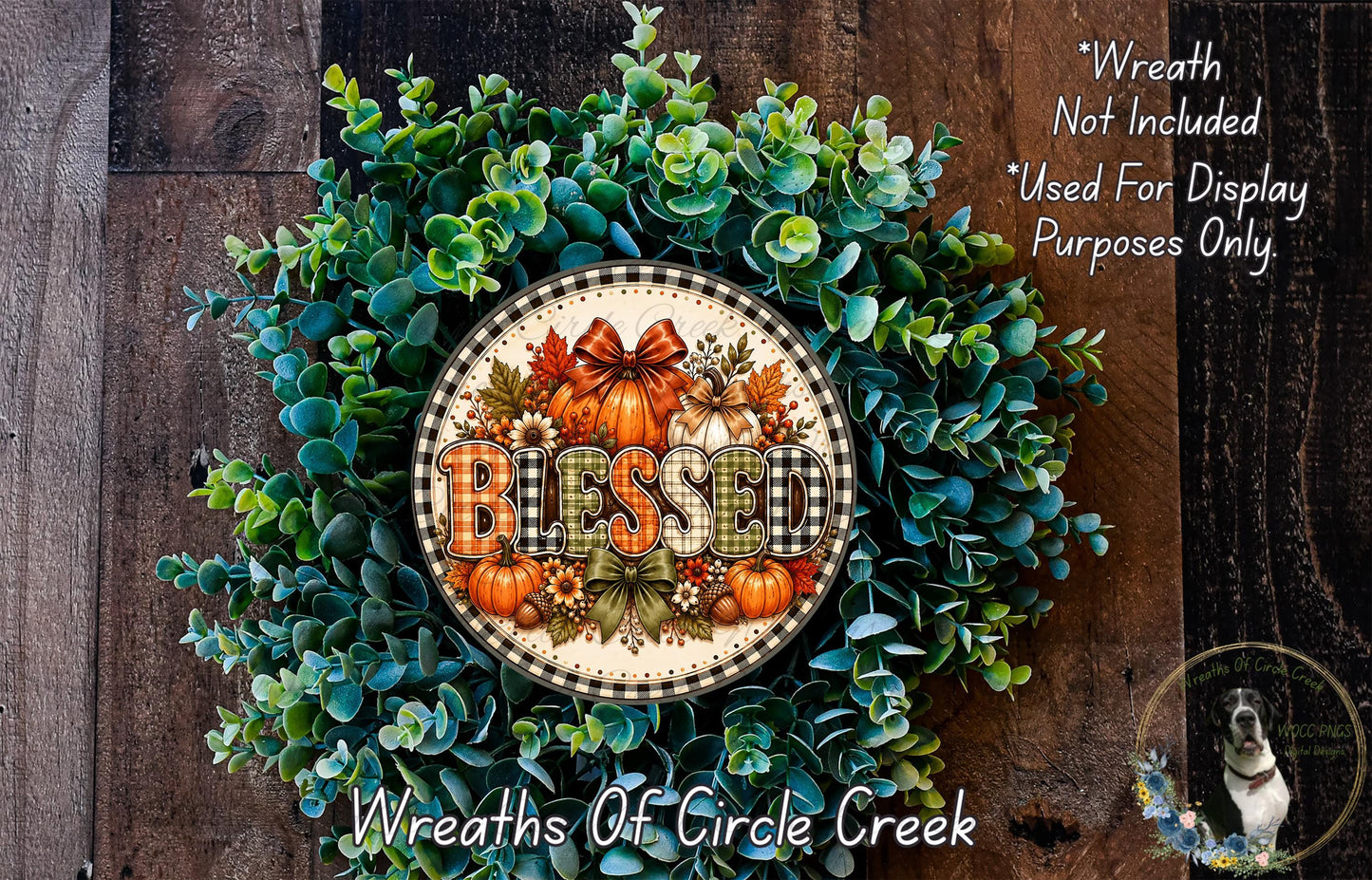 A wreath made of various fall foliage, including eucalyptus, pine cones, and pumpkins, with the word "Blessed" prominently displayed in the center.