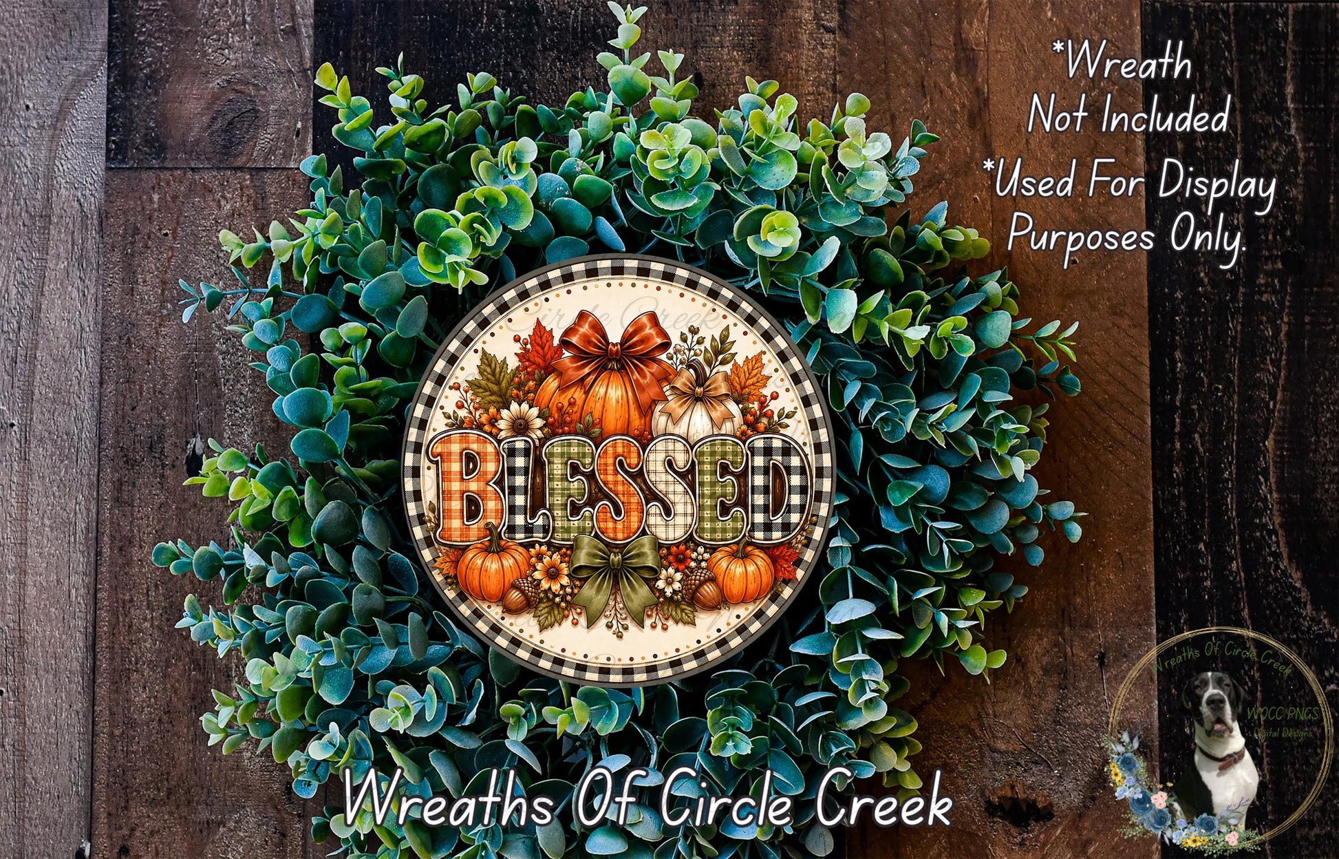 A wreath made of various fall foliage, including eucalyptus, pine cones, and pumpkins, with the word "Blessed" prominently displayed in the center.