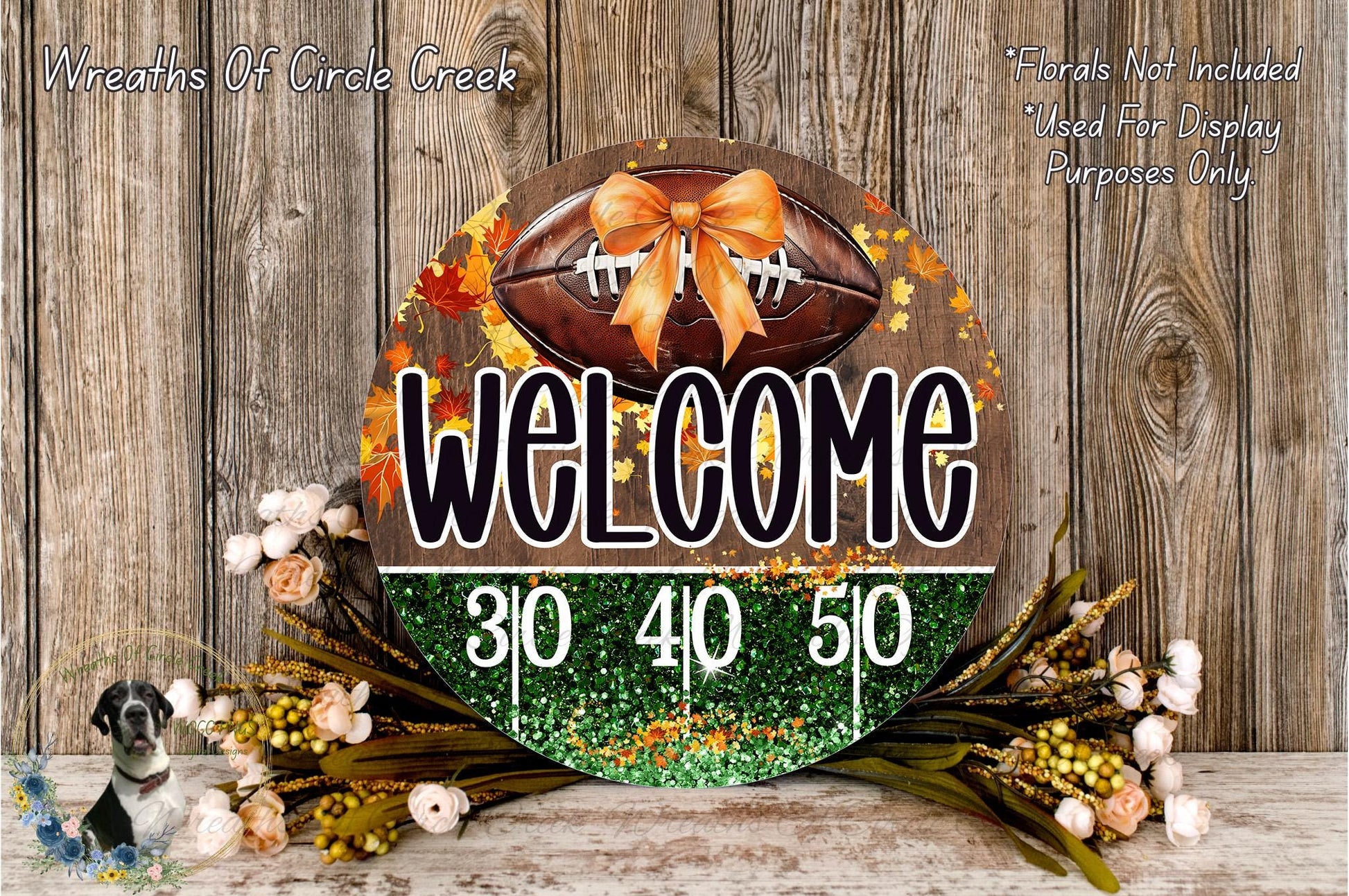 a welcome sign with a football and autumn leaves, surrounded by a floral arrangement and a wooden background.