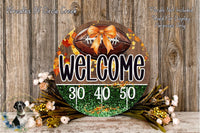 a welcome sign with a football and autumn leaves, surrounded by a floral arrangement and a wooden background.