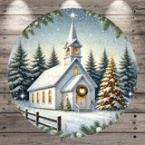 A white church with a steeple and a wreath on the front door, surrounded by snow-covered pine trees and a starry night sky.