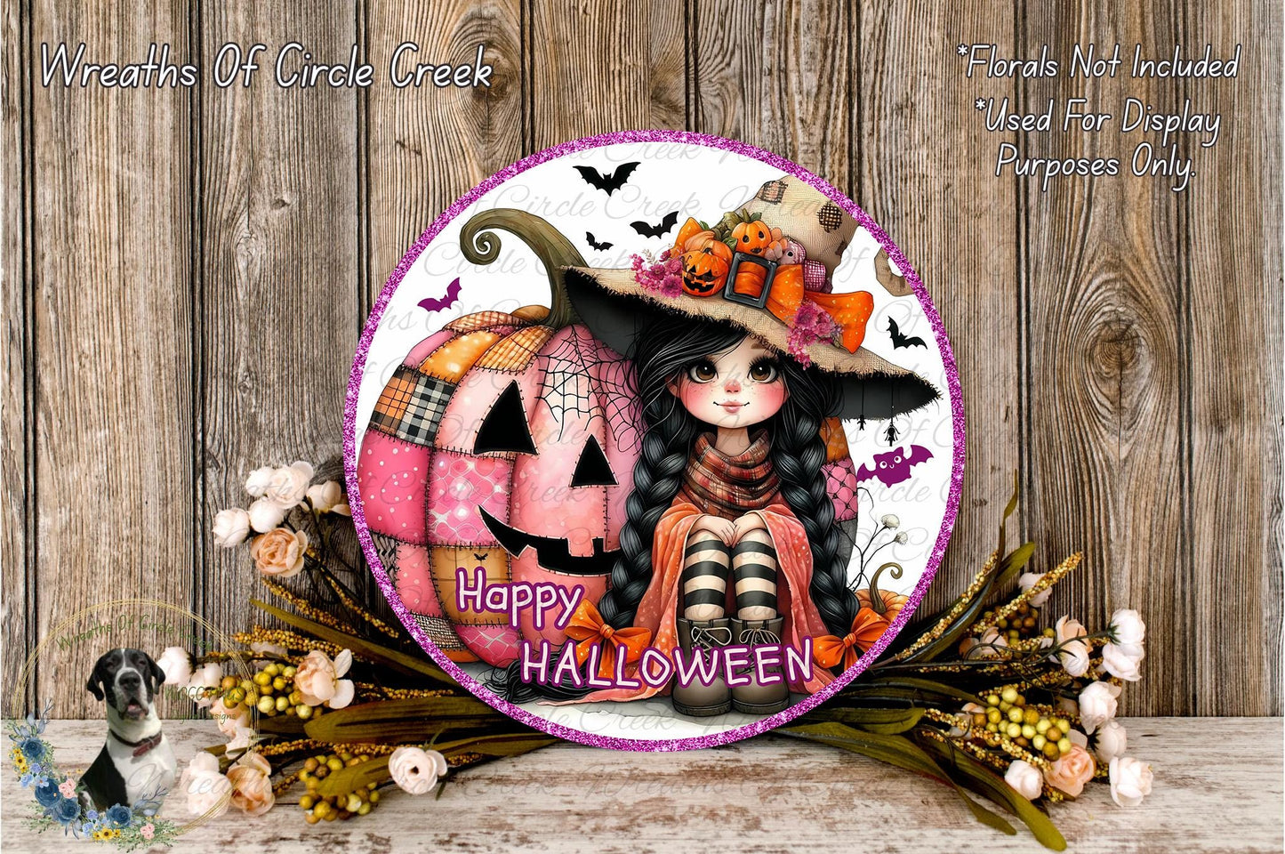 A Halloween-themed wreath with a pumpkin and a young girl wearing a witch's hat, surrounded by flowers and a wooden background.