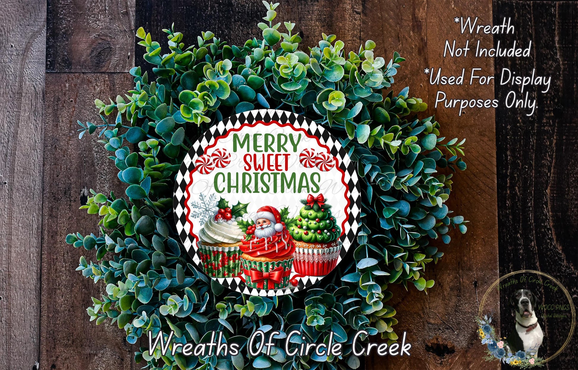 A wreath made of green leaves and decorated with cupcakes and a Santa Claus figure, with a "Merry Sweet Christmas" sign in the center.