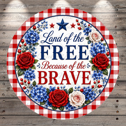 a patriotic design with a red, white, and blue border, surrounded by red, white, and blue flowers. The text "Land of the FREE Because of the BRAVE" is prominently displayed in the center of the design.