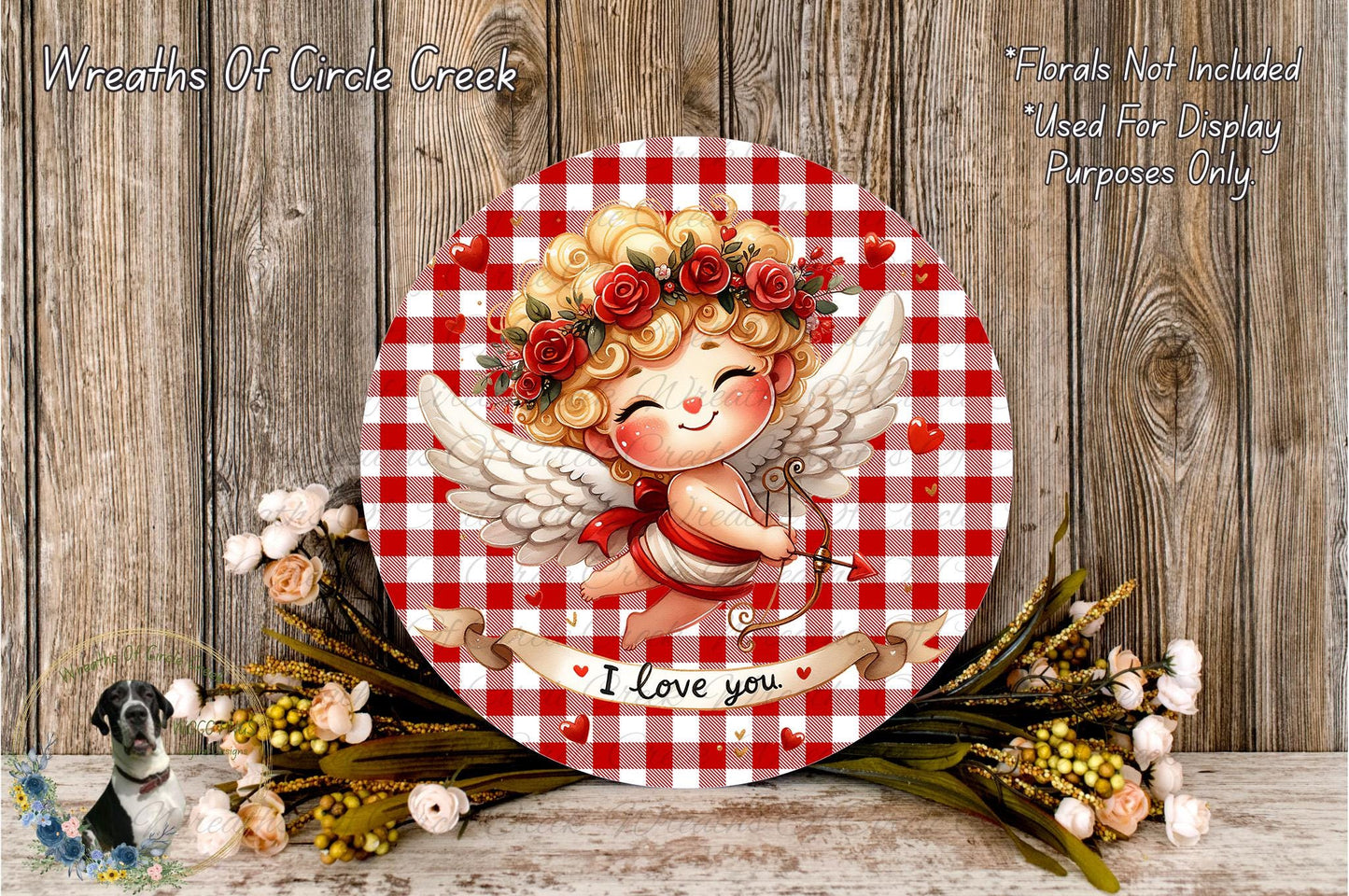 a round, red and white checkered plate with a smiling cupid holding a bow and arrow, surrounded by flowers and a banner that says "I Love you".