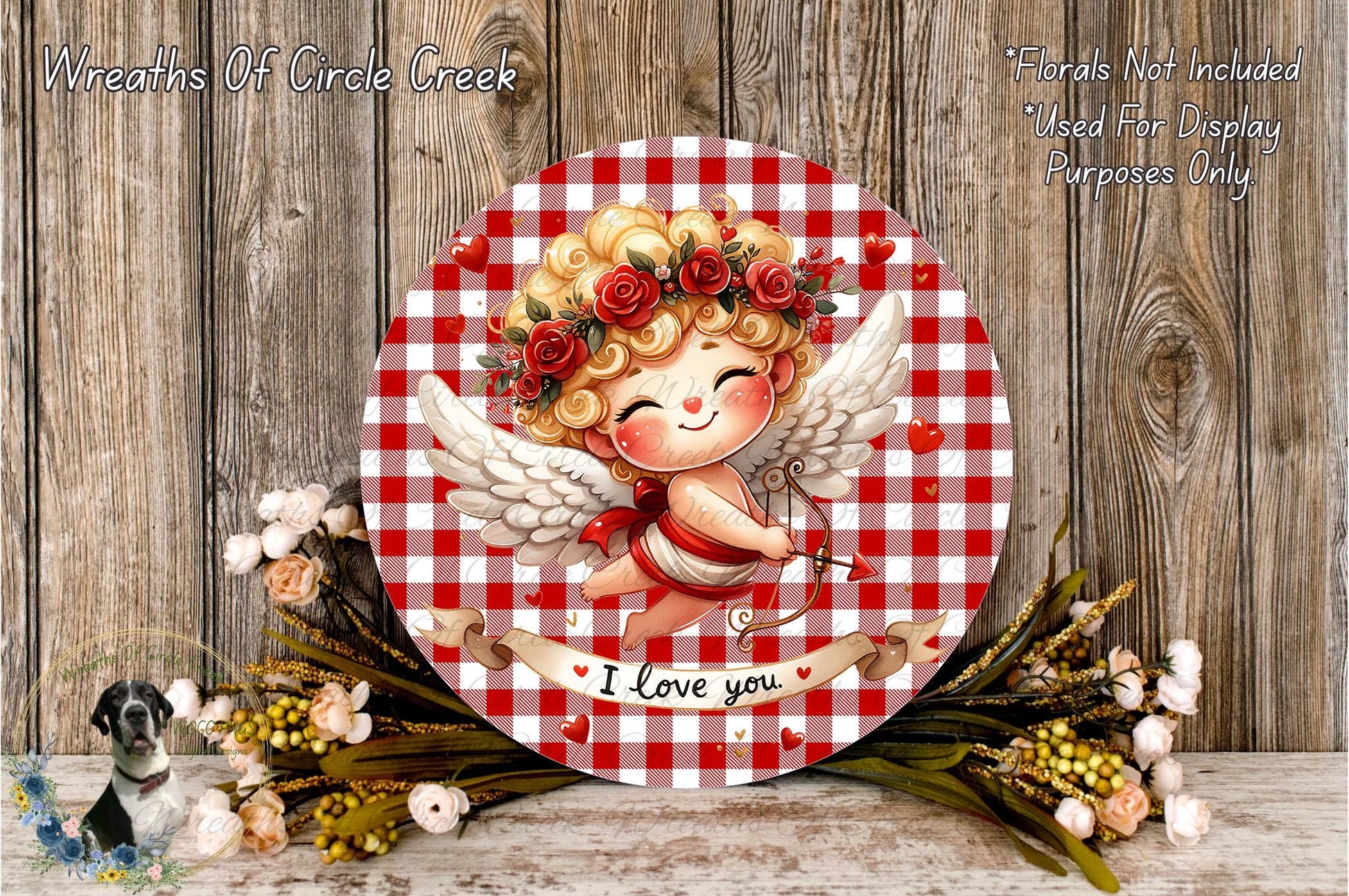 a round, red and white checkered plate with a smiling cupid holding a bow and arrow, surrounded by flowers and a banner that says "I Love you".