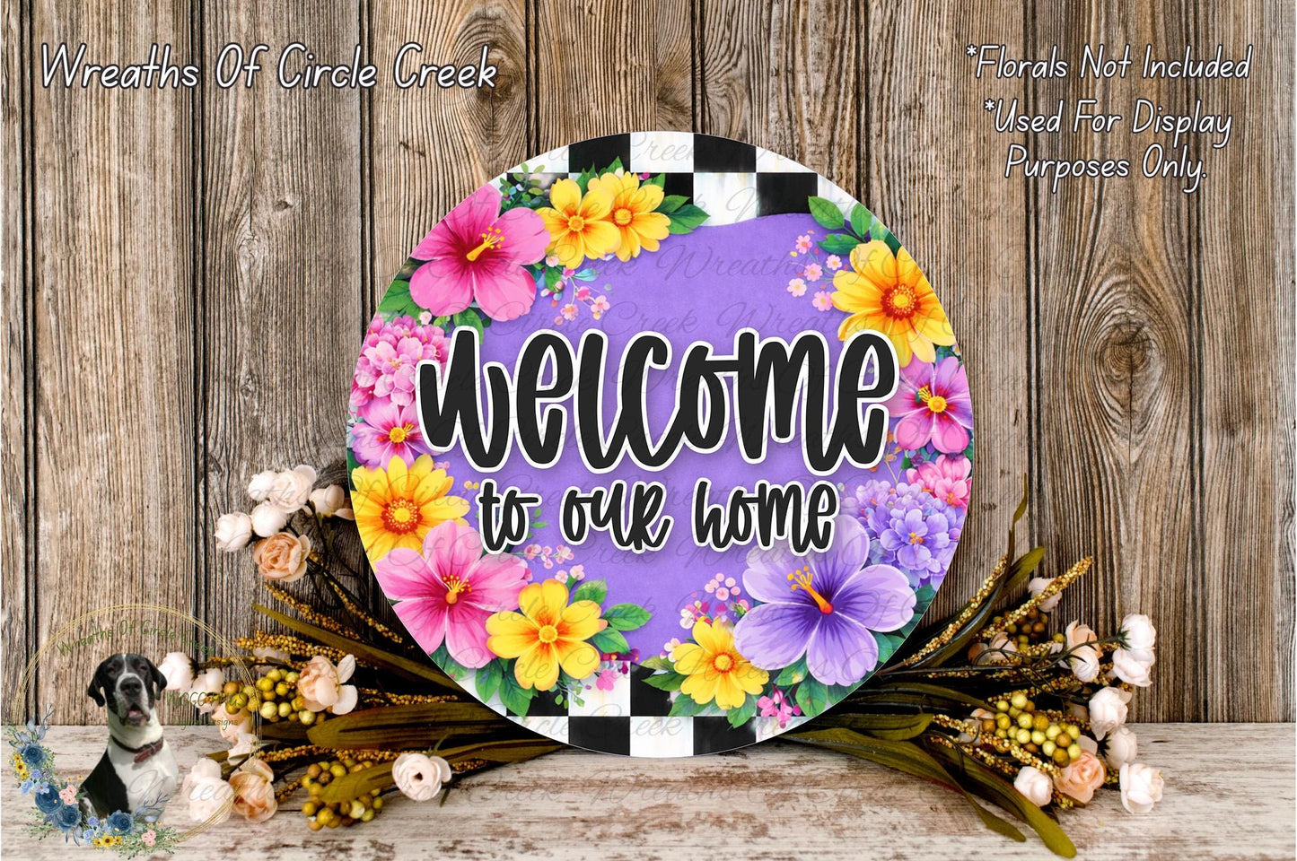 a colorful welcome sign with a floral design, placed on a wooden surface. The sign has the text "Welcome to our home" written on it, surrounded by a variety of colorful flowers.