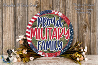 a patriotic-themed wreath with the text "Proud Military Family" displayed prominently. The wreath is surrounded by a floral arrangement, and the background is a wooden wall.