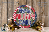 a patriotic-themed wreath with the text "Proud Military Family" displayed prominently. The wreath is surrounded by a floral arrangement, and the background is a wooden wall.