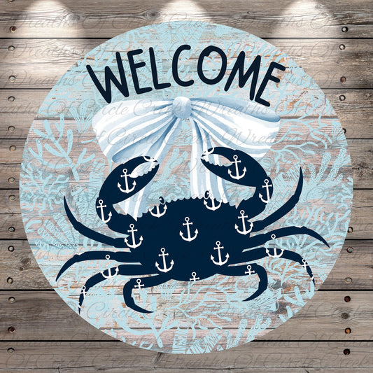 A circular sign with a blue crab and white anchors, surrounded by a white ribbon and the word "WELCOME" written on it.