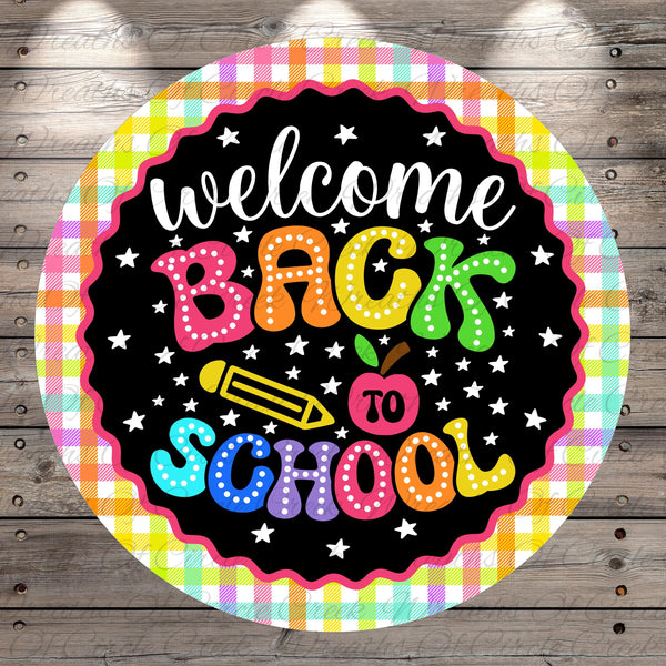 A colorful circular sign with the text "welcome back to school" written in a playful, cartoon-like font.