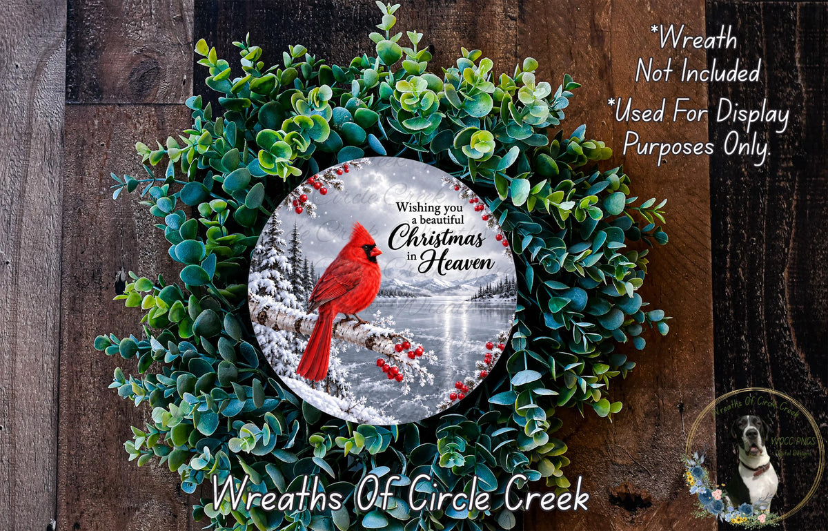 A wreath made of green foliage and red berries, with a red cardinal perched on a branch. The wreath is displayed on a wooden surface, and there is a text overlay that reads "Wreath Not Included * Used For Display Purposes Only".