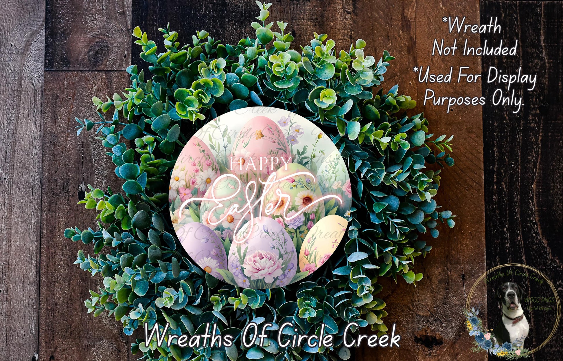a wreath made of green leaves and flowers, with a circular design in the center that includes the text "Happy Easter" surrounded by Easter eggs. The wreath is displayed on a wooden surface, and there is a small dog in the bottom right corner of the image.