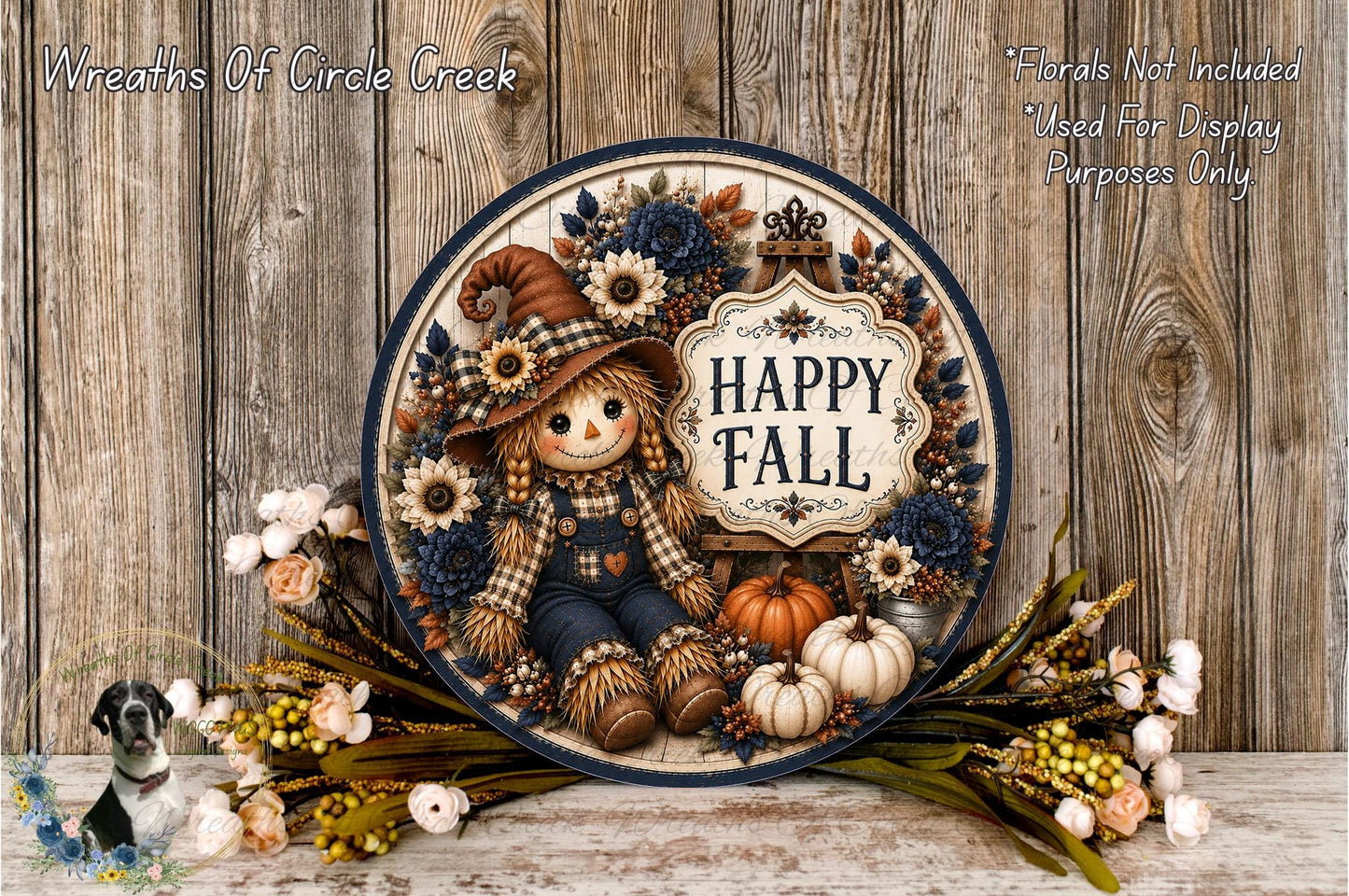 A decorative wreath with a scarecrow figure, pumpkins, and fall-themed flowers, including a sign that says "Happy Fall". The wreath is displayed on a wooden surface, surrounded by additional fall-themed decorations.