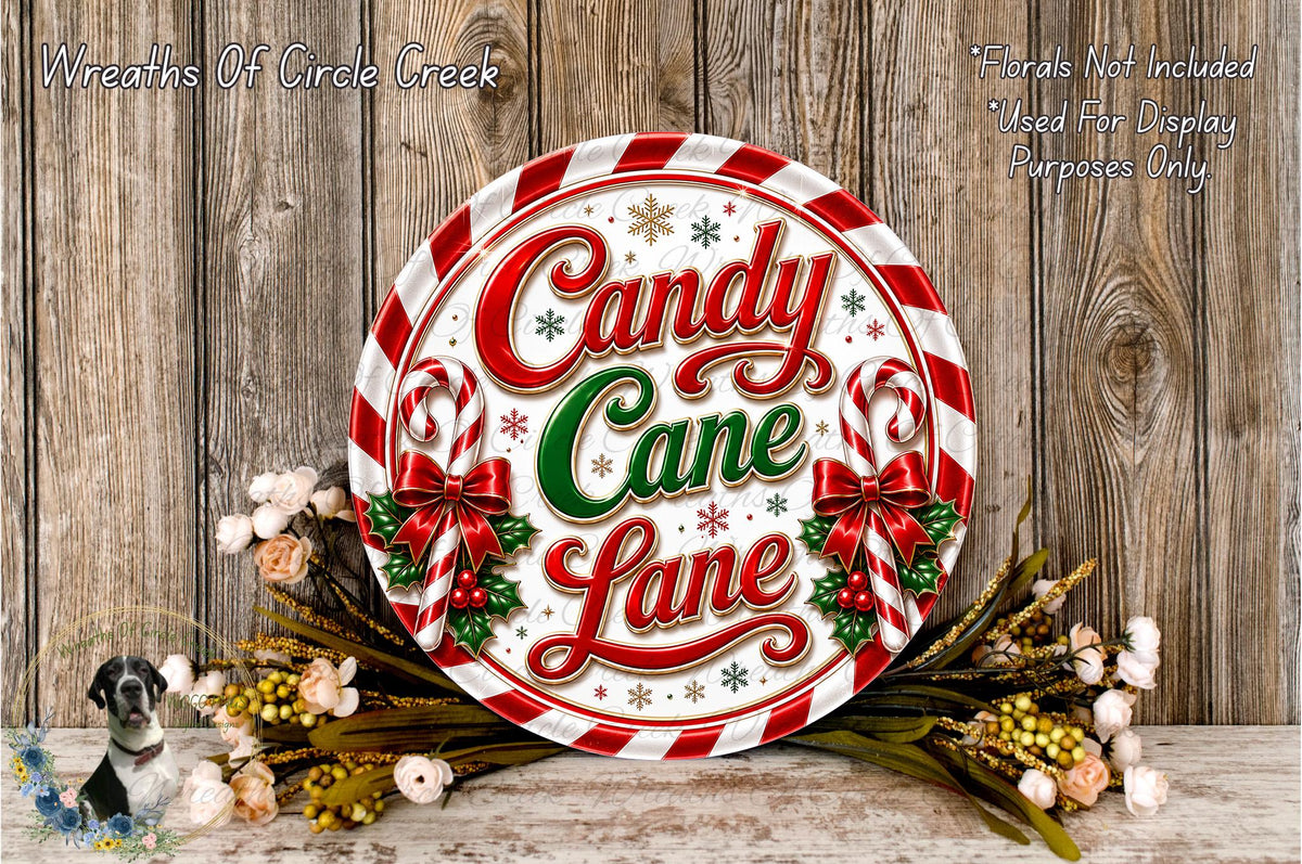 a decorative sign for "Candy Cane Lane" with a festive design, surrounded by a wreath of Christmas-themed flowers and greenery.