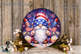 A round, decorative plate featuring a gnome holding a firework and a cake, surrounded by flowers and a wooden background.