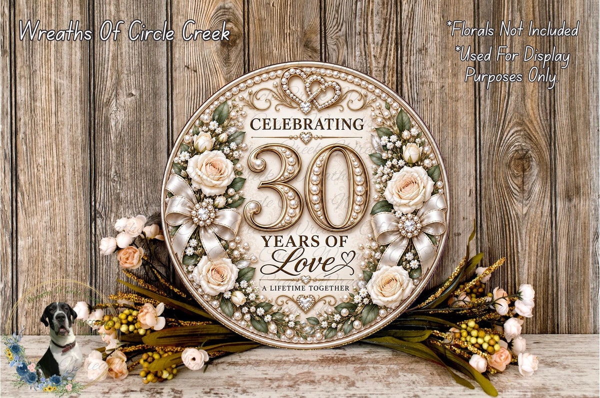 A decorative sign celebrating 30 years of love, surrounded by flowers and greenery, with a wooden background.