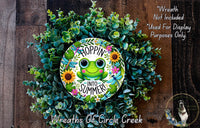 a wreath with a green frog painted on it