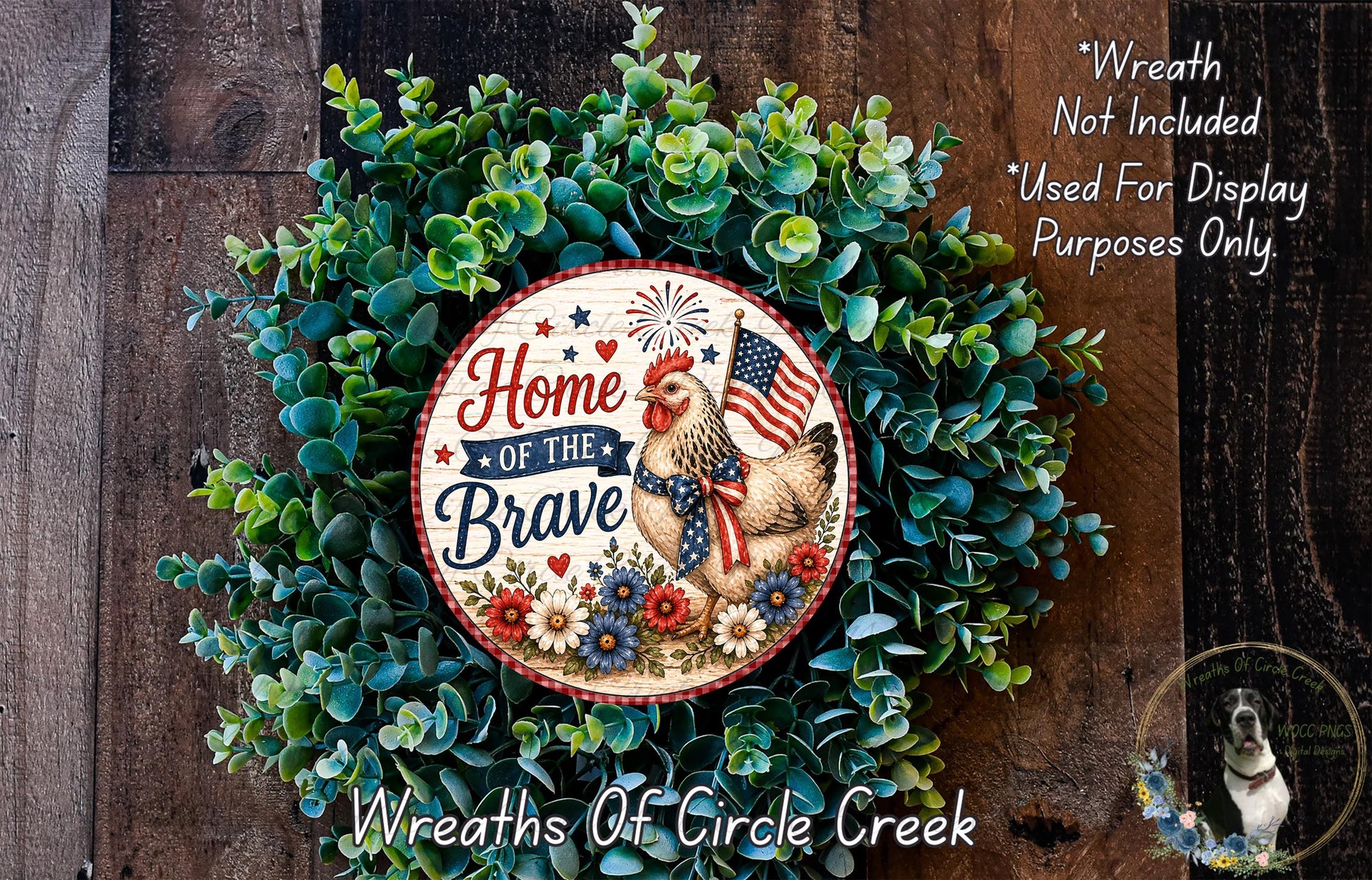 a wreath with the text "Home of the Brave" and an American flag, surrounded by greenery. The wreath is displayed on a wooden surface, and there is a small dog in the bottom right corner.
