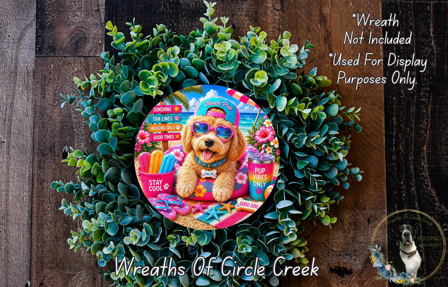 A wreath featuring a dog wearing sunglasses and a hat, surrounded by green foliage, with a sign that says "Wreath Not Included * Used For Display Purposes Only".