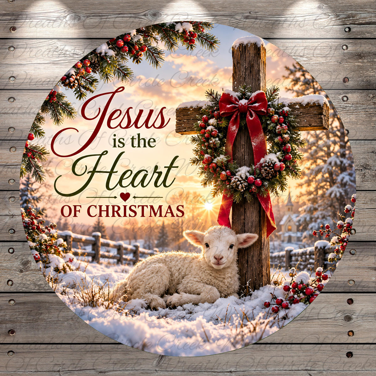 A white lamb rests on a snowy field, with a cross and a wreath of berries and pine branches surrounding it. The text "Jesus is the Heart of Christmas" is displayed above the lamb.