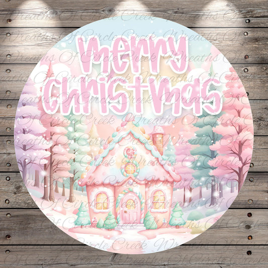 A circular image featuring a pink and blue Christmas-themed scene with a small house, trees, and snow. The text "Merry Christmas" is prominently displayed in the center of the image.