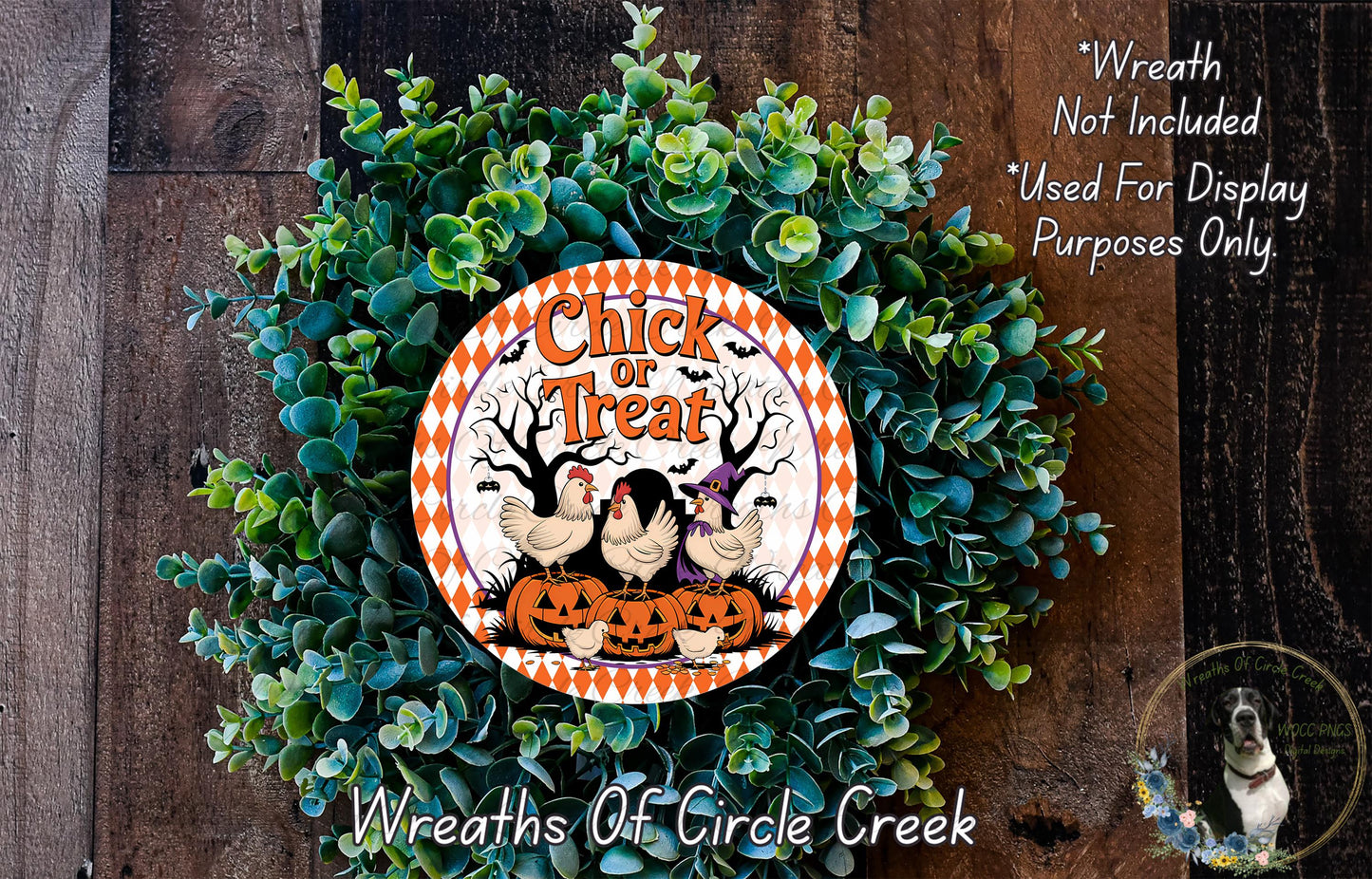 a wreath made of green foliage and a decorative orange and white sign that reads "Chick or Treat". The sign is surrounded by a sprig of greenery, creating a festive and seasonal atmosphere.