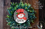 A wreath made of green leaves and a snowman decoration, with the text "LET IT SNOW" displayed on it.