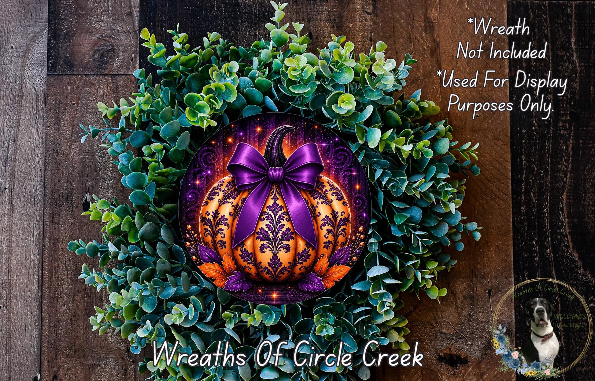a wreath with a purple bow and a pumpkin design, surrounded by greenery. The wreath is displayed on a wooden surface, and there is a small dog in the background.