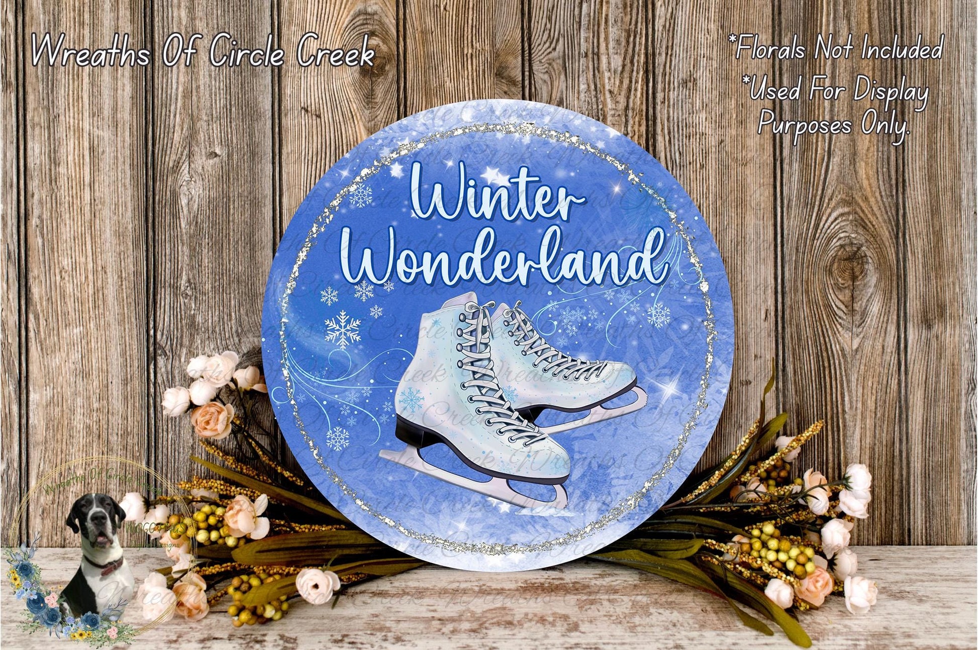 A round blue sign with the words "Winter Wonderland" and an illustration of ice skates, surrounded by flowers and a wooden background.