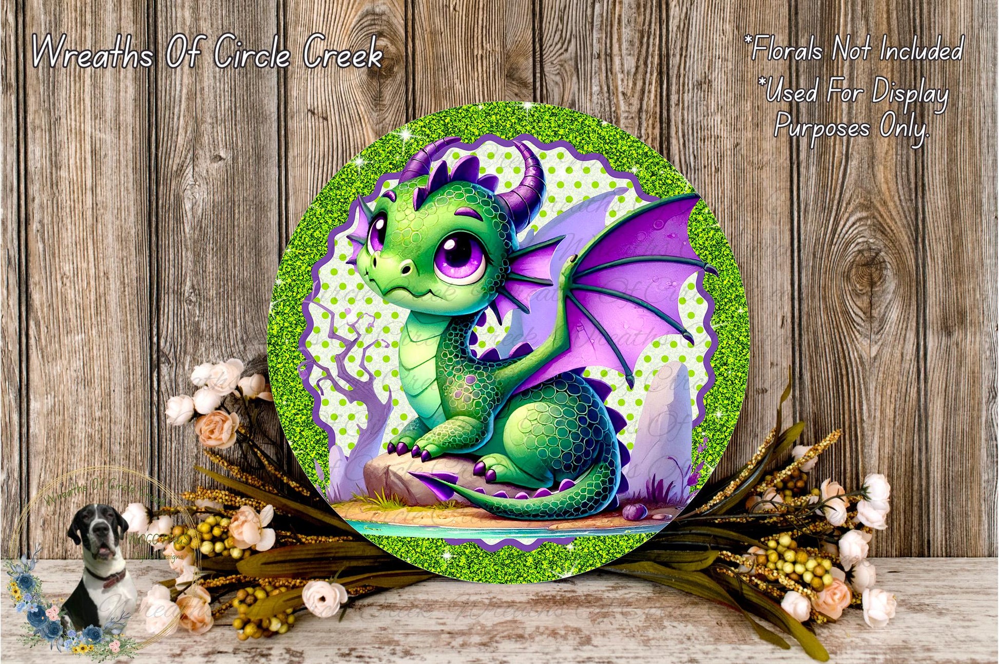 A colorful, whimsical dragon illustration is displayed on a circular plaque, surrounded by a wreath of flowers and foliage.