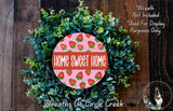 a wreath made of green leaves and red strawberries, with the text "Home Sweet Home" displayed prominently in the center.