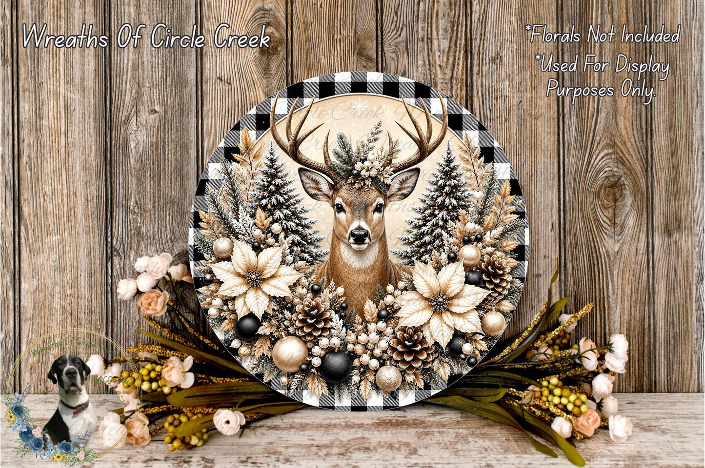 A decorative wreath featuring a deer head surrounded by pine cones, pine branches, and flowers, placed on a wooden surface.