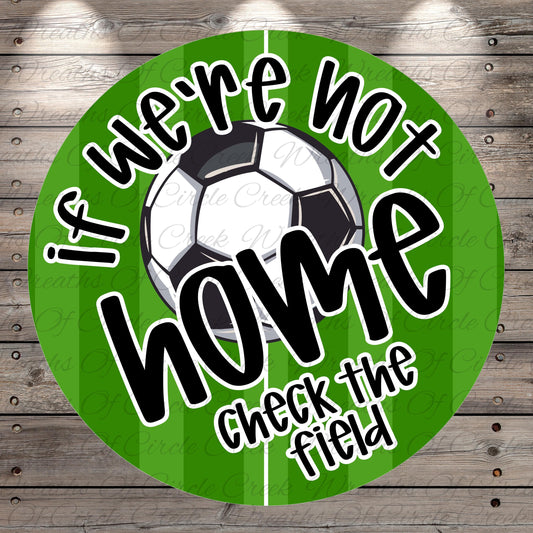 a soccer ball and a green background with the text "If we're not home, check the field" written on it.