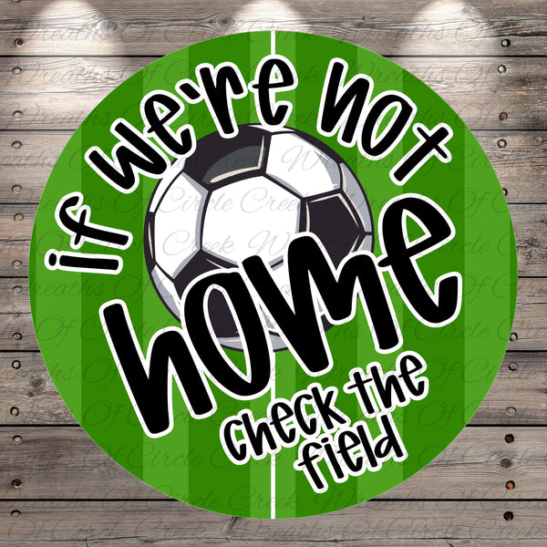 a soccer ball and a green background with the text "If we're not home, check the field" written on it.