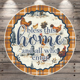 a decorative plate with a plaid border and a message that reads "Bless this home and all who enter".